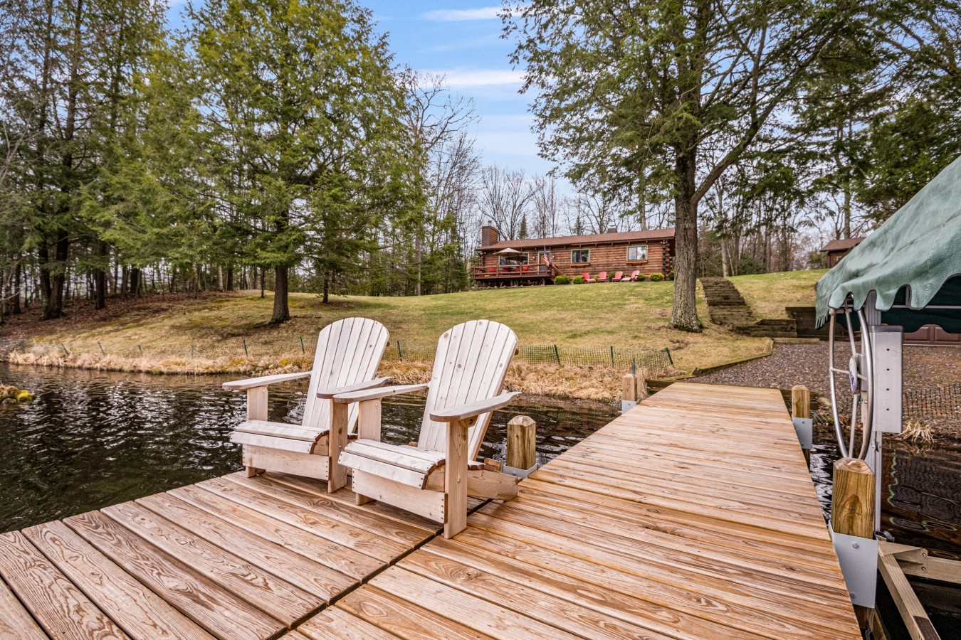Unwind on your private dock with Adirondack chairs, watching gentle ripples dance across the water while the peaceful forest surrounds you.