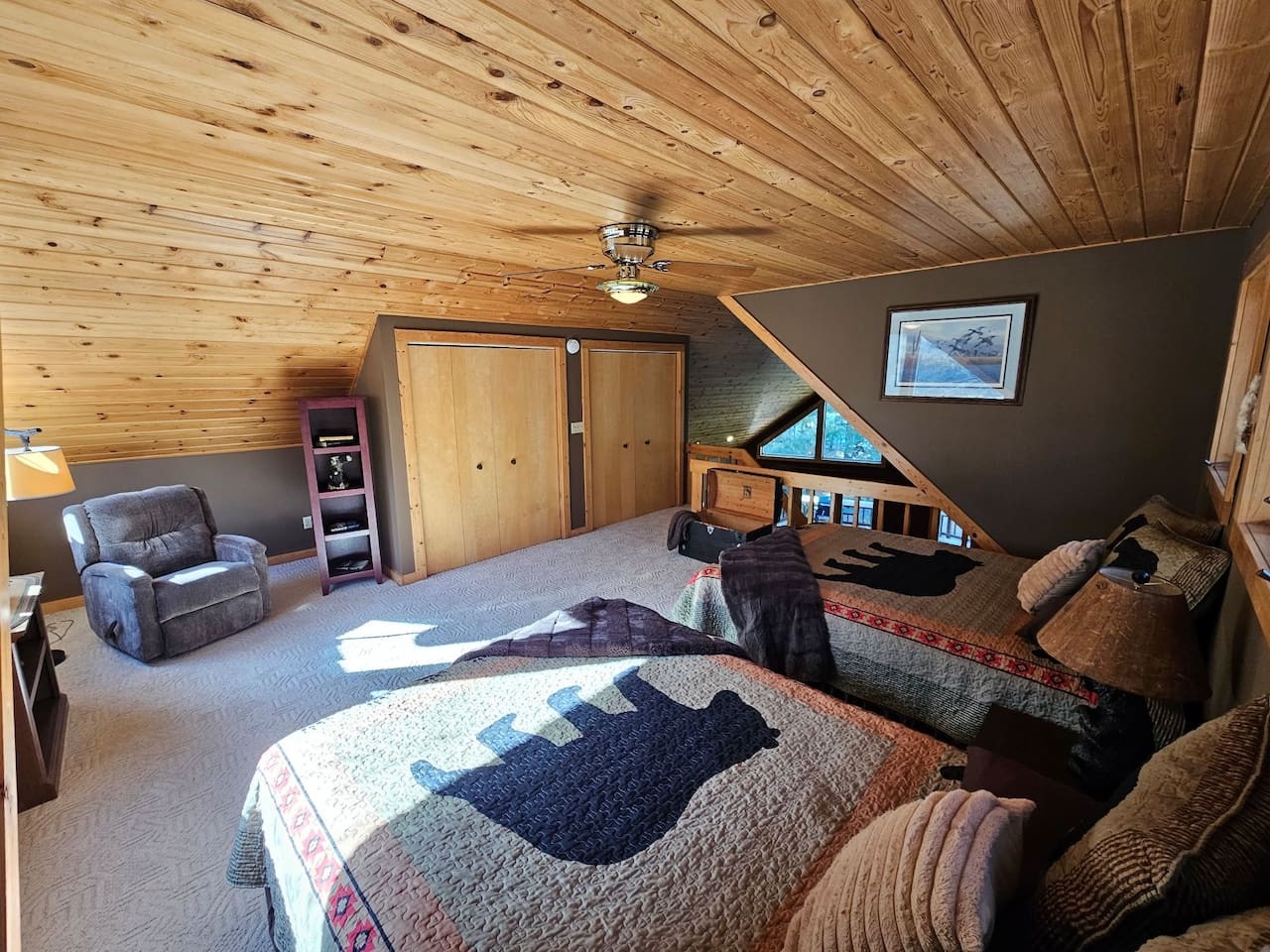 Cozy under the rustic wood ceiling, your private loft bedroom offers peaceful mountain views and charming handcrafted touches for the perfect retreat.