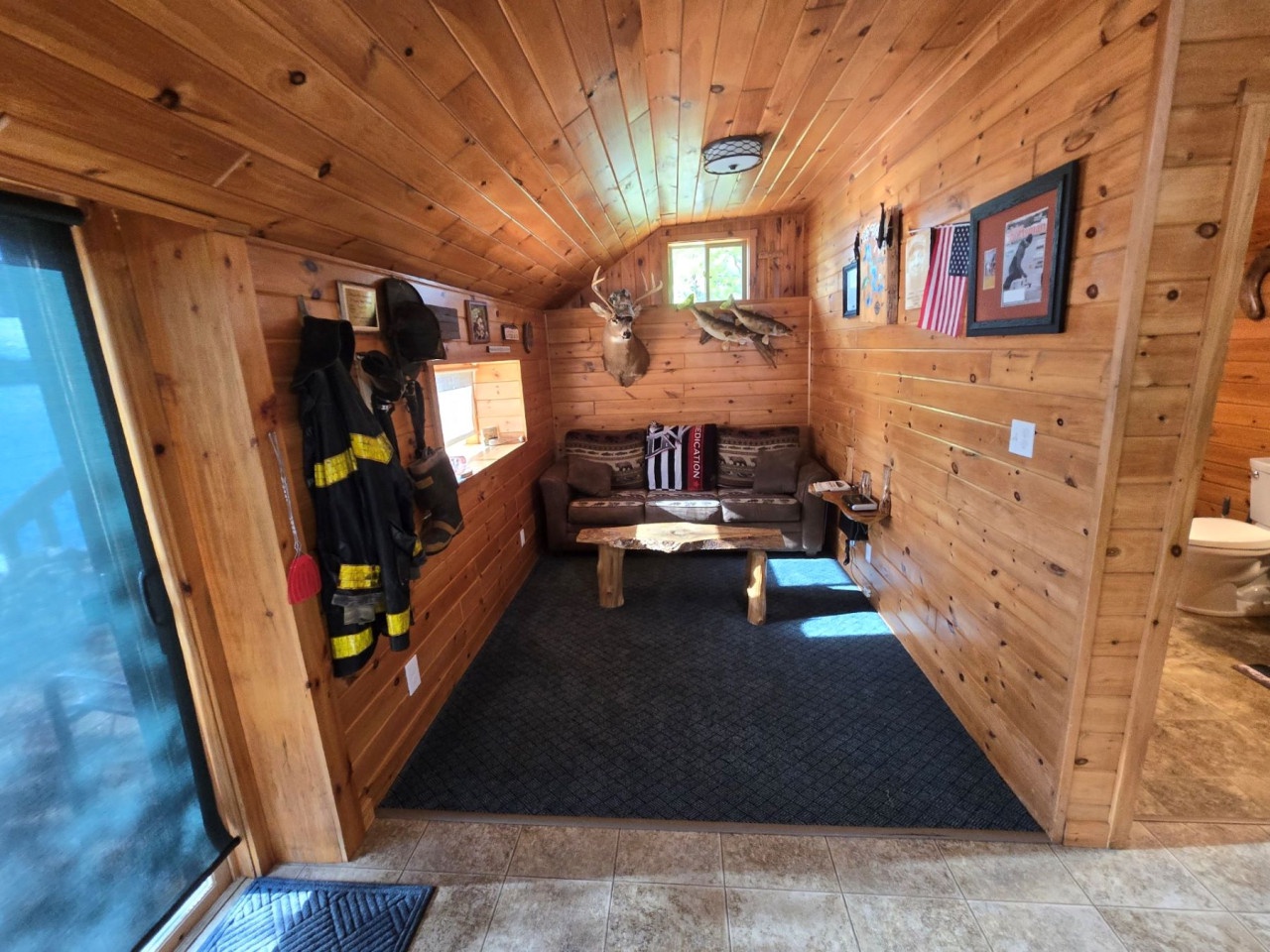 Step into your cozy log cabin living room where rustic wood walls create warmth and character you'll love.
