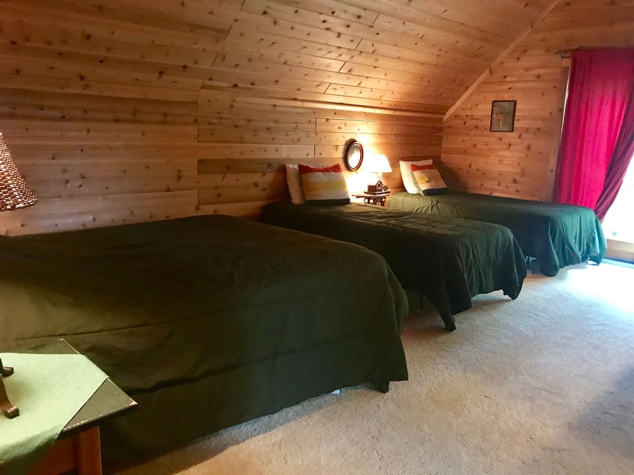 Rest peacefully in this charming log cabin bedroom with twin beds and warm wood walls creating your cozy mountain retreat.