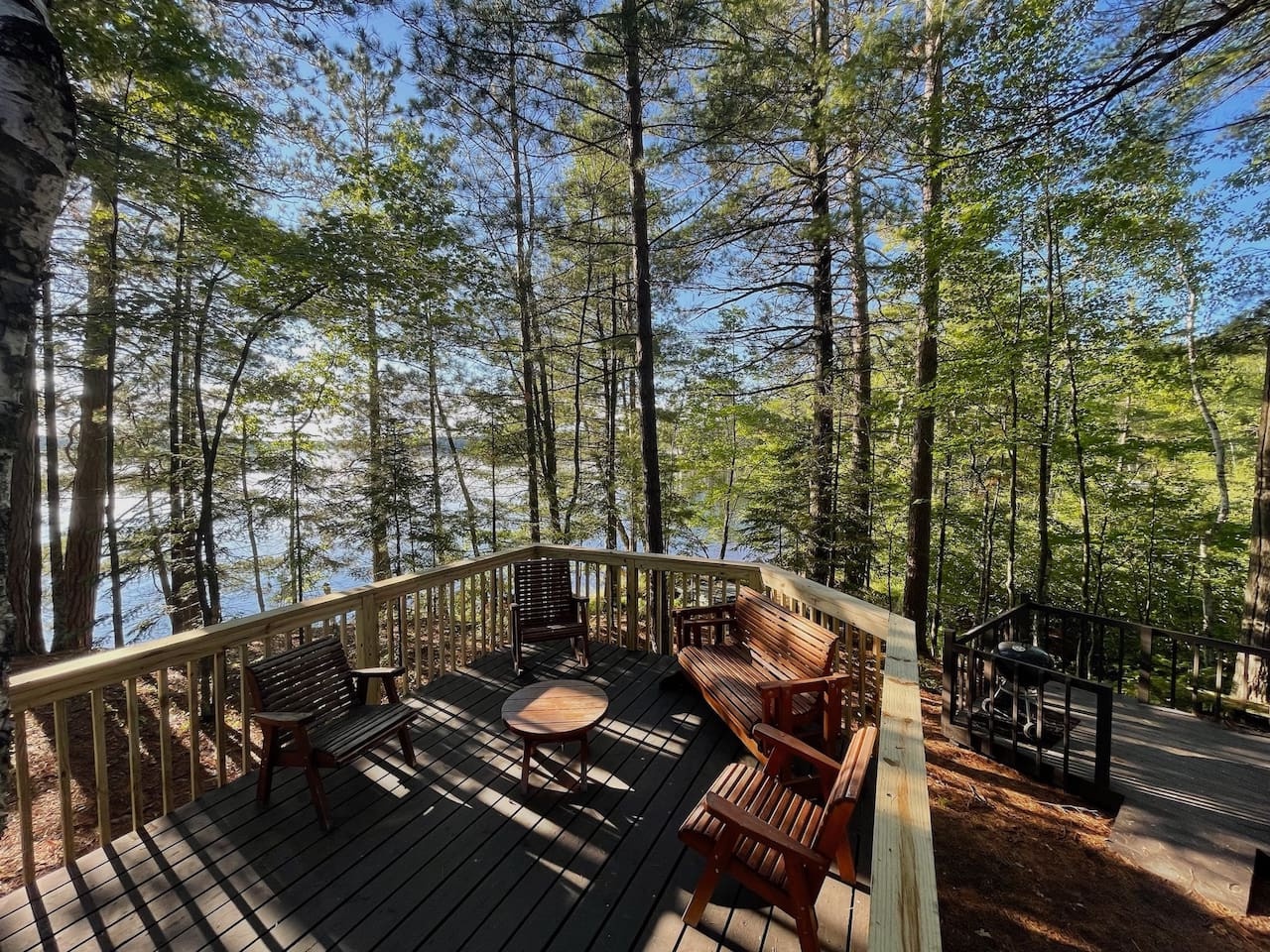 Unwind on your private deck surrounded by towering trees, where morning coffee and evening conversations feel magical among the forest canopy.