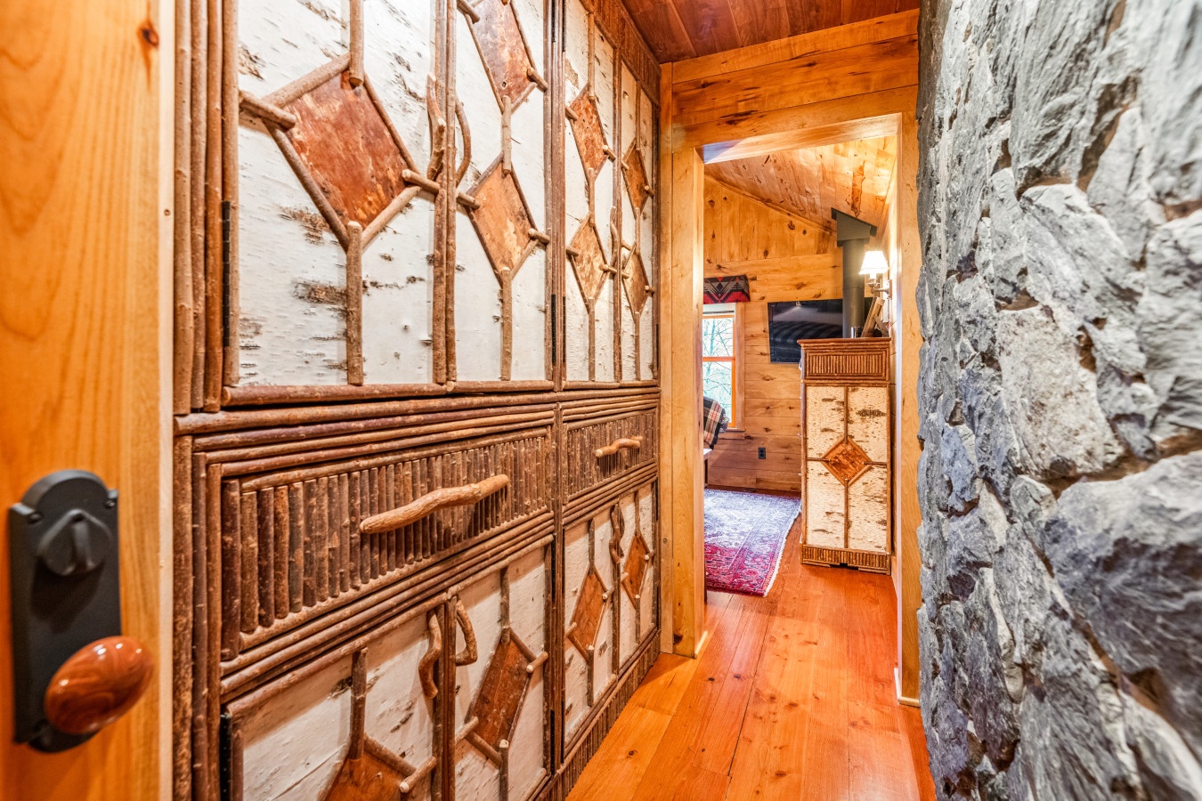 Step through handcrafted wooden doors into your rustic retreat, where authentic stone walls and warm timber create an inviting mountain escape.