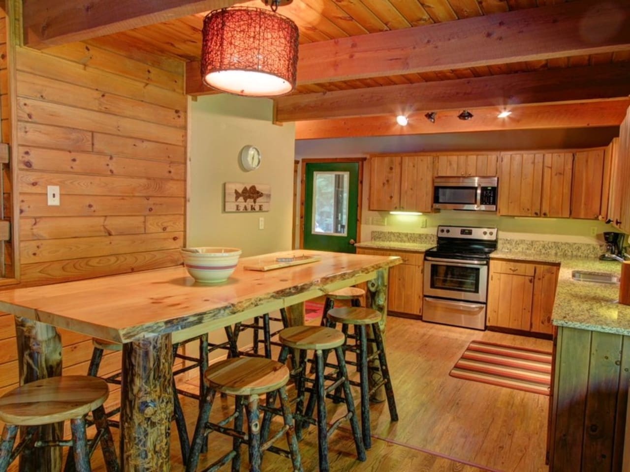 Gather around your rustic kitchen island for morning coffee or evening meals in this charming wood-beamed space.