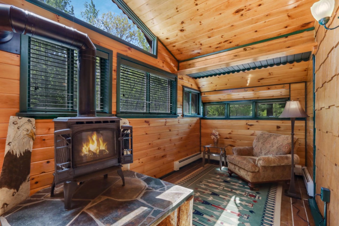 Cozy up by your crackling wood-burning fireplace as natural light streams through panoramic windows, creating the perfect mountain retreat atmosphere.