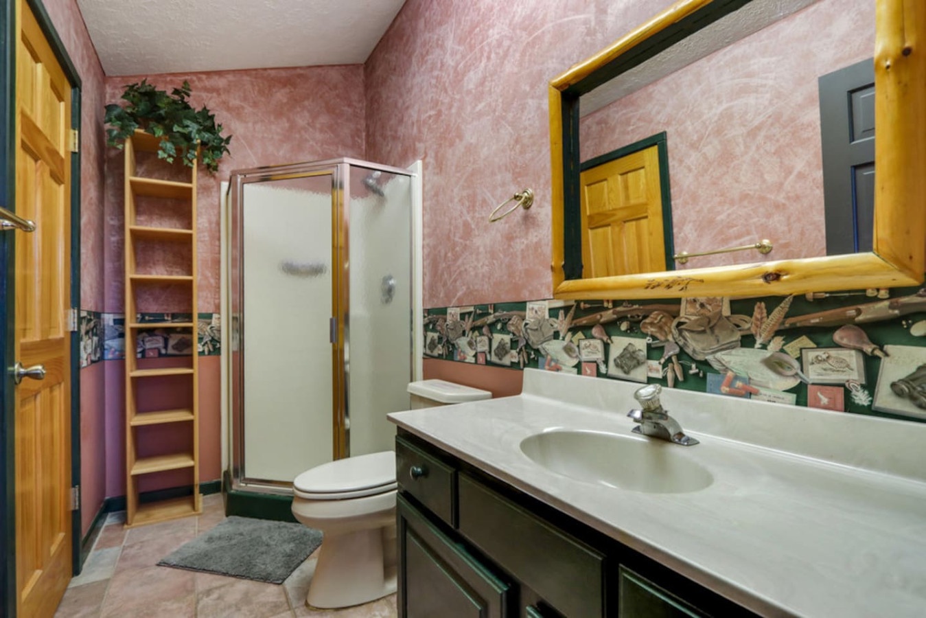 Step into your private bathroom featuring a spacious shower, thoughtful storage, and charming decorative touches that make freshening up feel special.