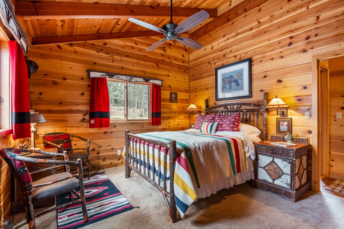 Drift off to sleep in your cozy log cabin bedroom, surrounded by warm wood and vibrant Southwest-inspired textiles.