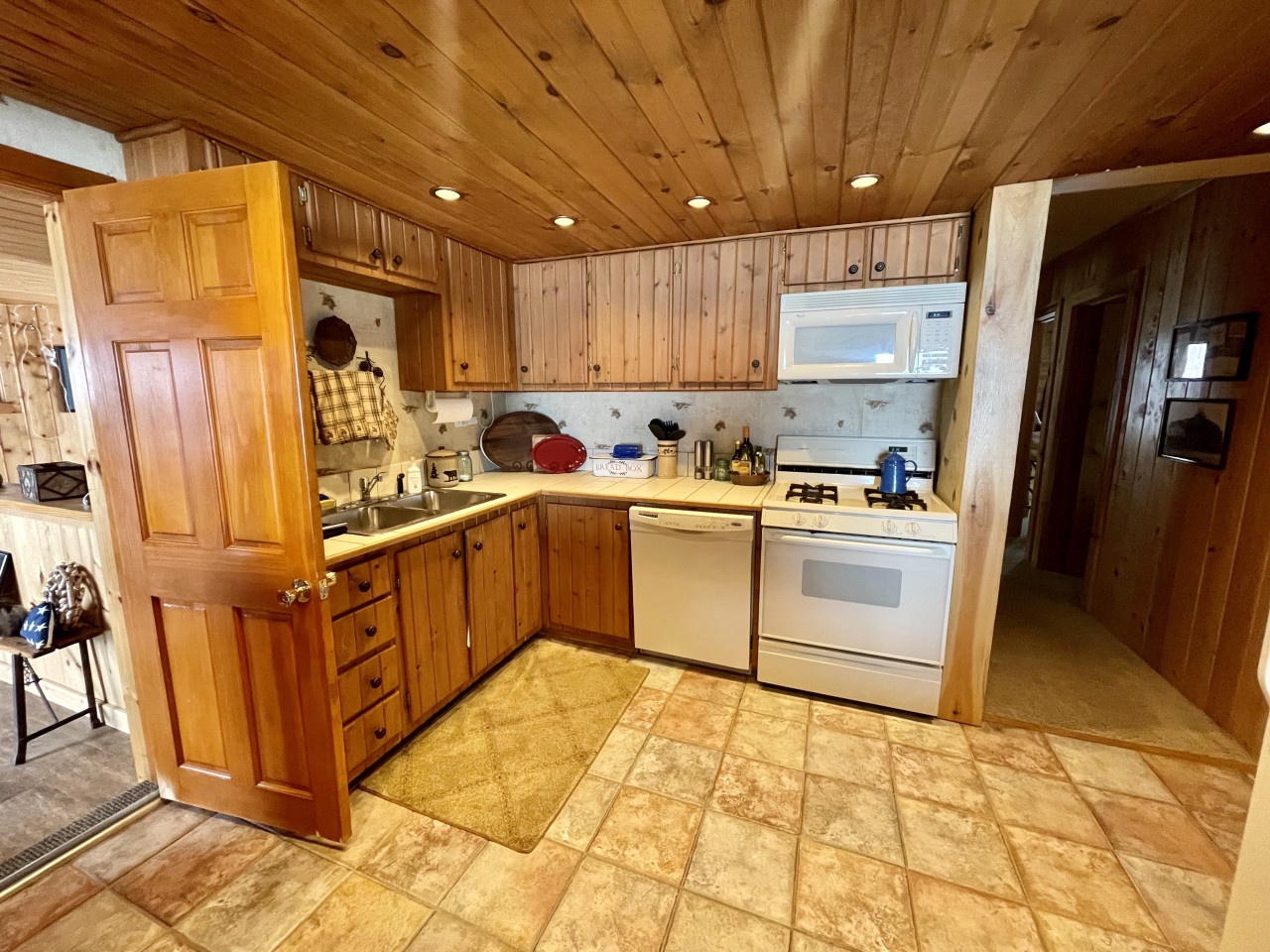 Your fully-equipped cabin kitchen features warm wood cabinetry and all appliances needed to create memorable meals during your mountain retreat.