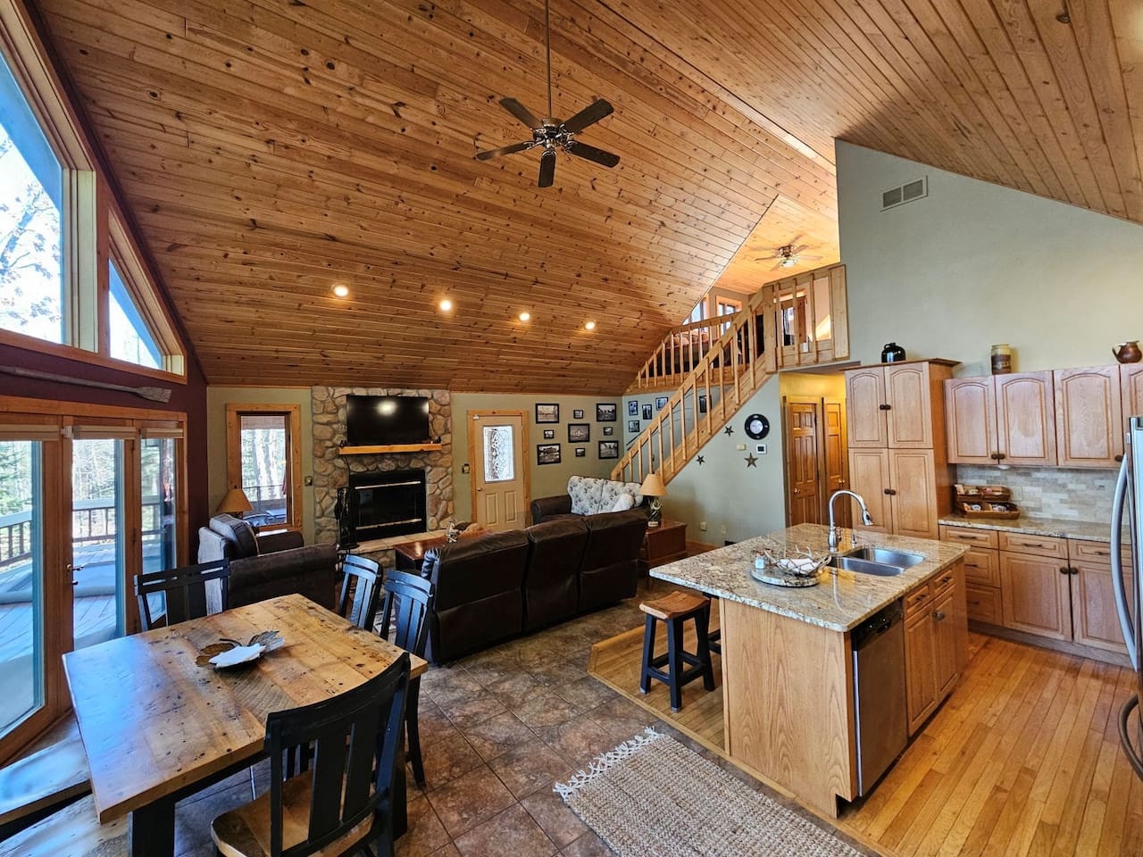 Relax in your open-concept cabin with vaulted wood ceilings, stone fireplace, and fully equipped kitchen—perfect for memorable mountain getaways.