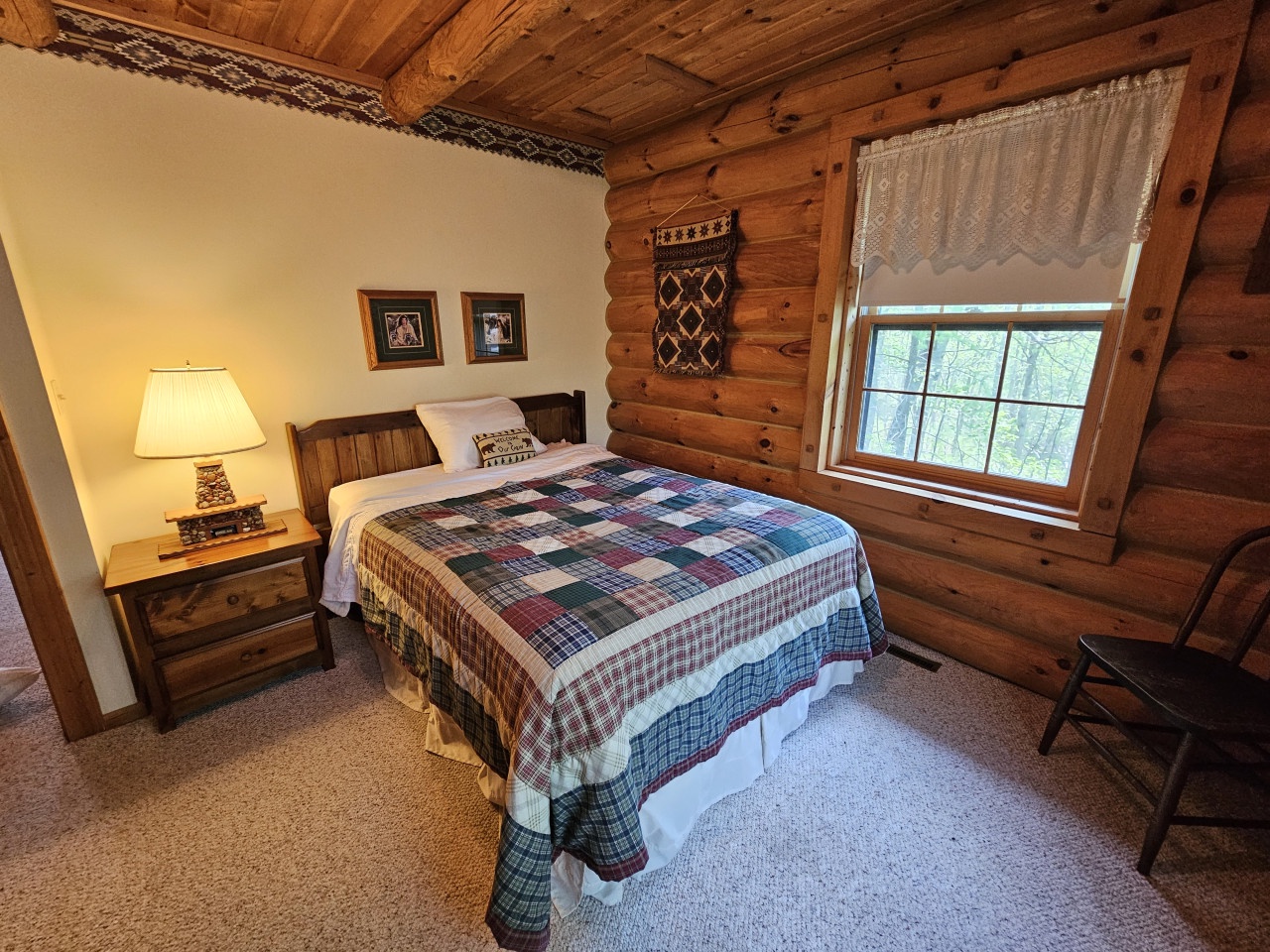 Cozy rustic bedroom with handcrafted quilt and warm wood accents for peaceful mountain retreat nights.