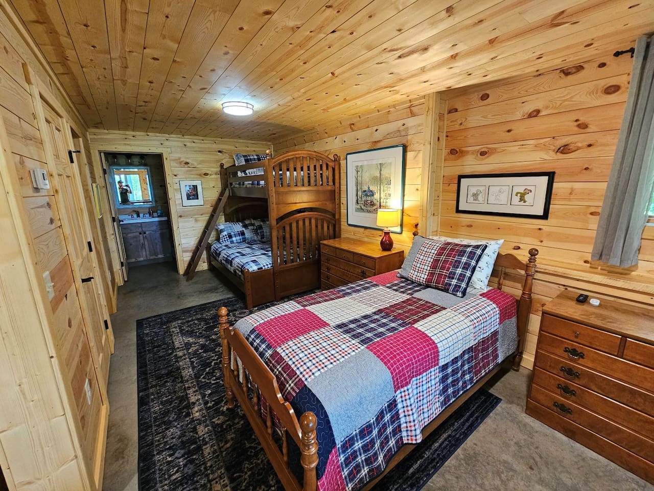 Cozy log cabin bedroom with rustic charm features comfortable beds and warm wood paneling for your perfect retreat.