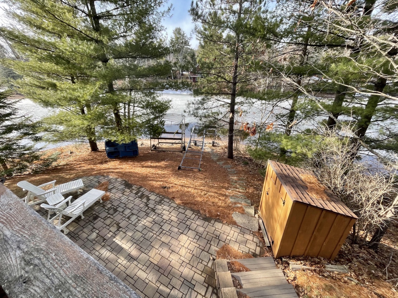 Private lakeside retreat with sauna, loungers, and direct water access nestled among tall pines.