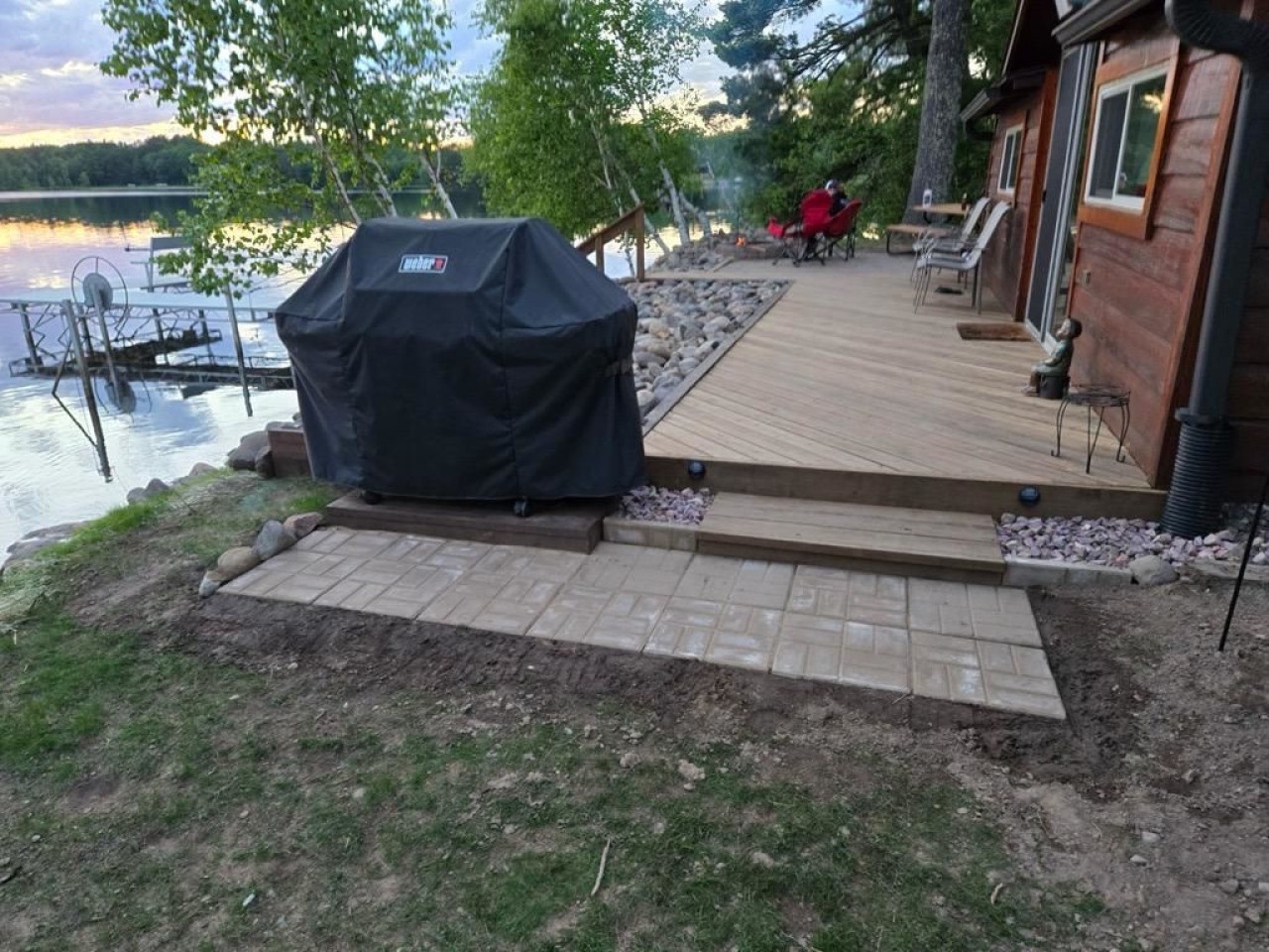 Waterfront cabin with private deck, outdoor grilling station, and scenic lake views for the perfect peaceful getaway.