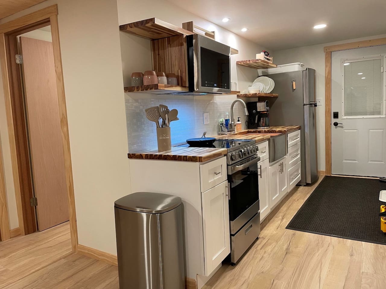 Your fully equipped kitchen features warm wood counters, modern appliances, and thoughtful touches that make cooking feel like home.