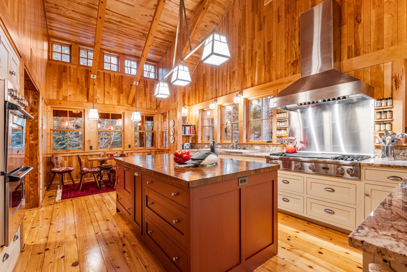 Step into your rustic chef's dream with warm wood beams, granite counters, and professional appliances perfect for mountain getaway cooking.