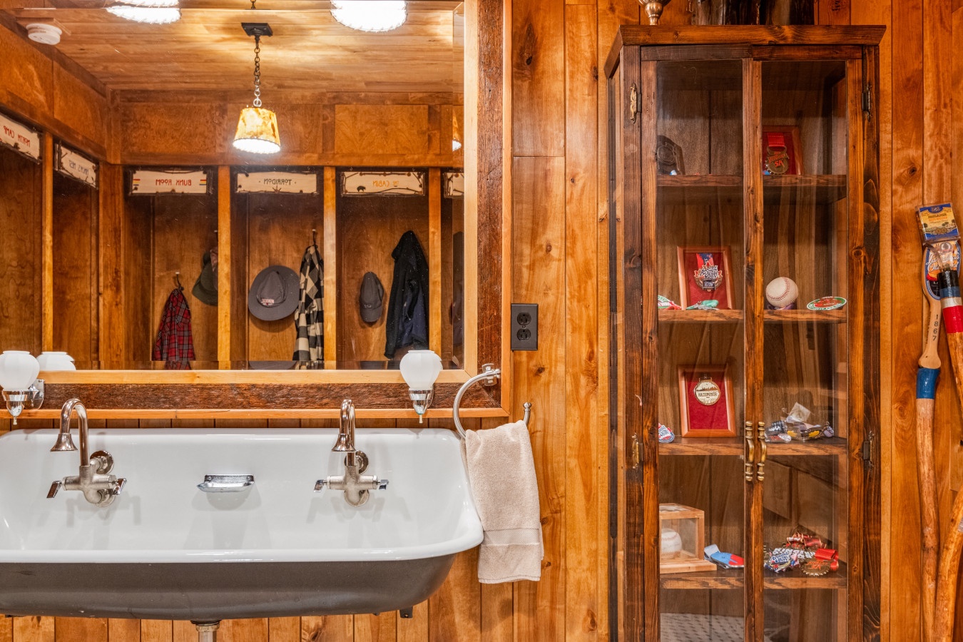 Step into this rustic bathroom where warm wood surrounds you and vintage-style fixtures invite relaxation after your mountain adventures.