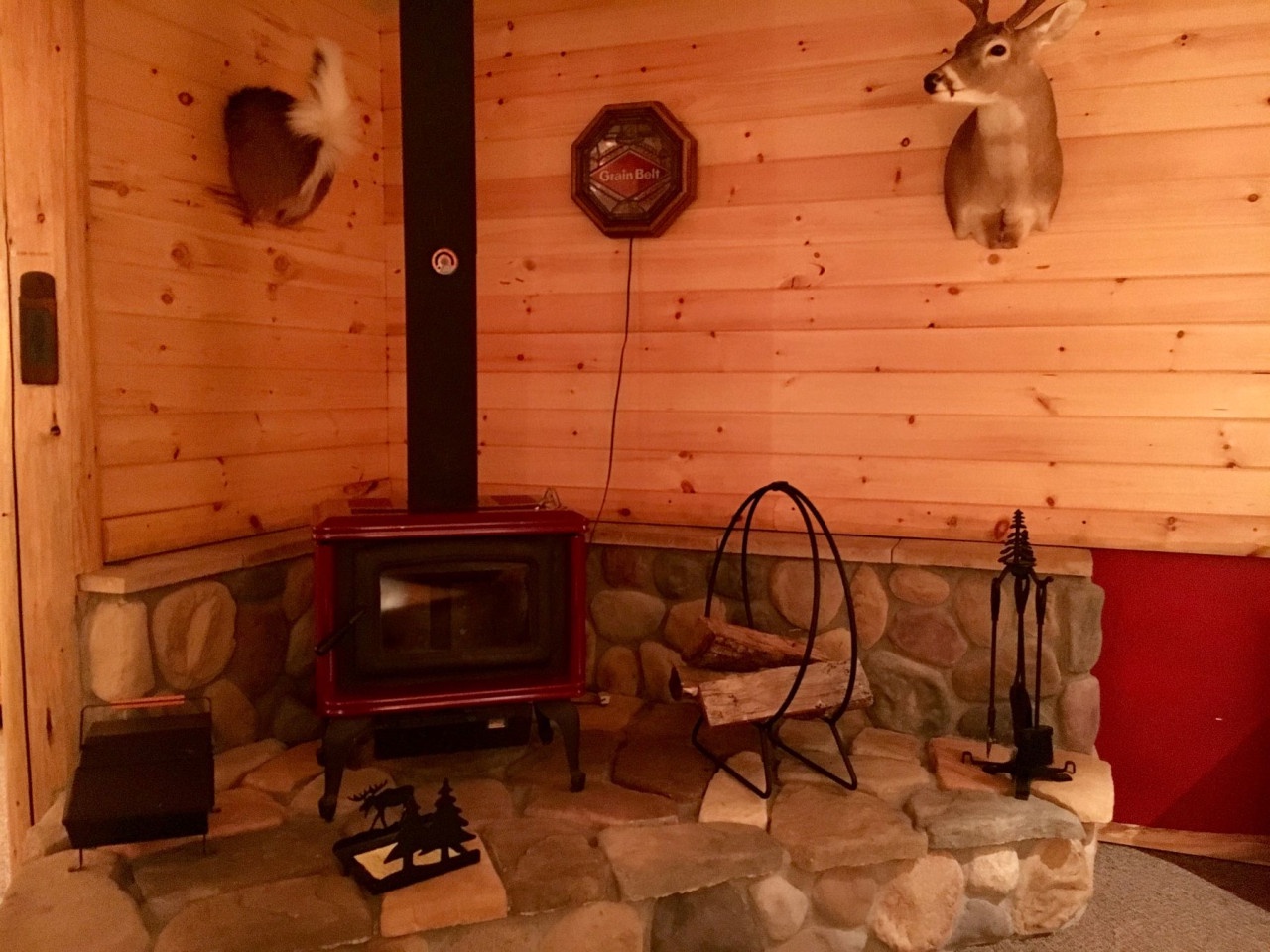 Cozy up by your wood-burning fireplace surrounded by rustic stone and warm cabin walls that create the perfect mountain retreat atmosphere.