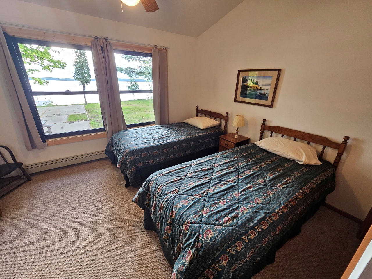 Rest peacefully in your cozy twin bedroom with stunning lake views right outside your window.