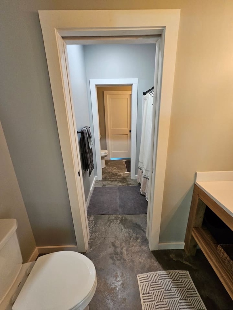 Step into your private bathroom with modern finishes and thoughtful details, featuring fresh towels and a convenient connecting layout for easy access.