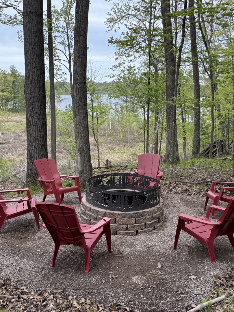 Gather around the stone fire pit with lake views peeking through the trees—your perfect spot for evening stories and s'mores.