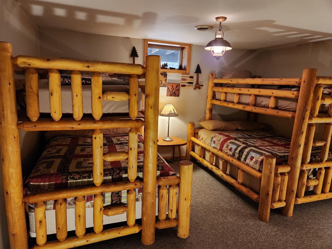 Sleep soundly in your cozy log bunk room, where rustic charm meets comfort with warm wood and peaceful mountain views.