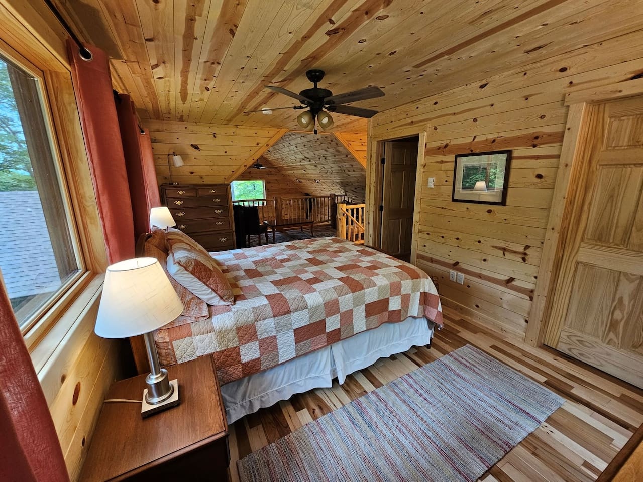 Rest peacefully in this charming log cabin bedroom with rustic wood walls, cozy quilt bedding, and warm natural lighting for your mountain retreat.