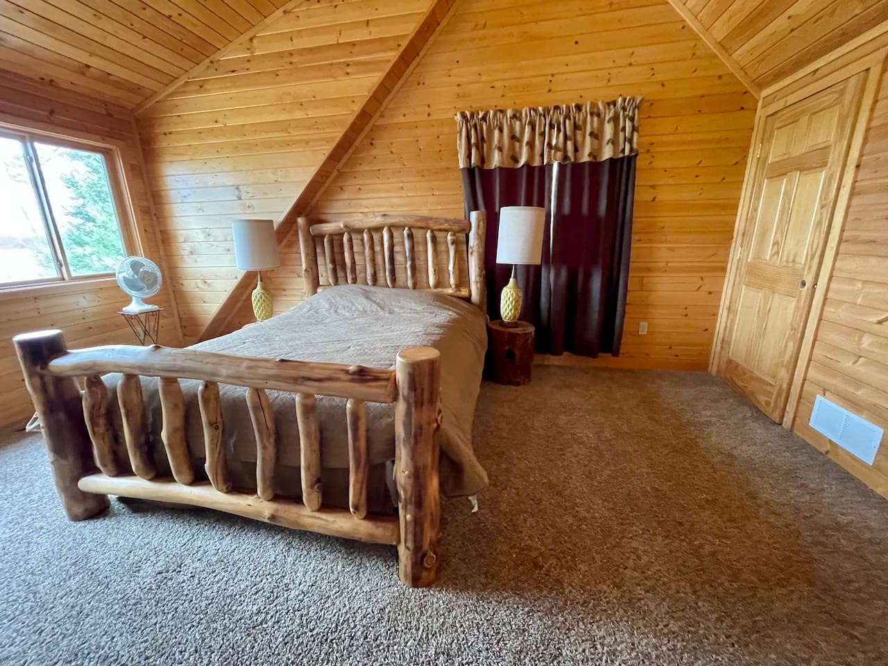 Drift off peacefully in your charming log cabin bedroom, where rustic wood beams and handcrafted log furniture create the perfect mountain retreat.