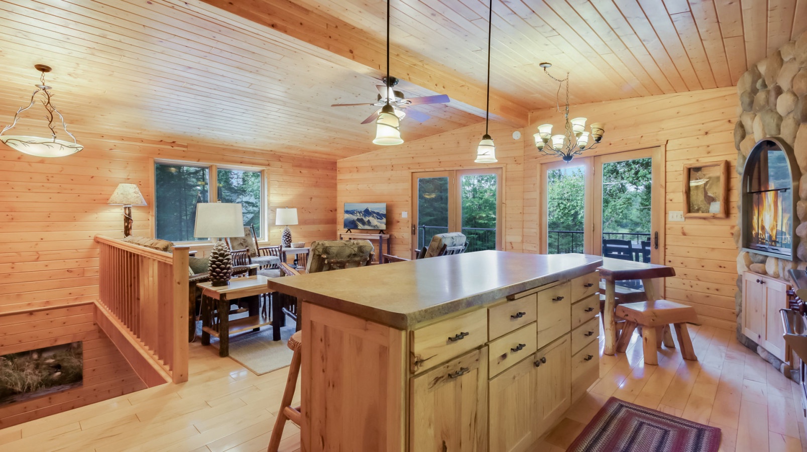 Gather around this stunning rustic kitchen island where morning coffee and evening meals become cherished memories in your cozy cabin retreat.