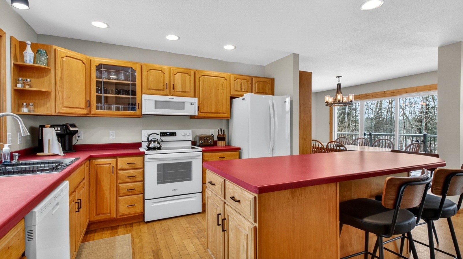 Your fully equipped kitchen features warm wood cabinets, modern appliances, and a spacious island perfect for cooking family meals.