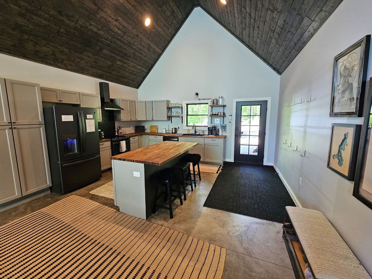 Your gourmet kitchen features stunning wood ceilings, modern appliances, and a spacious island perfect for cooking memorable meals together.