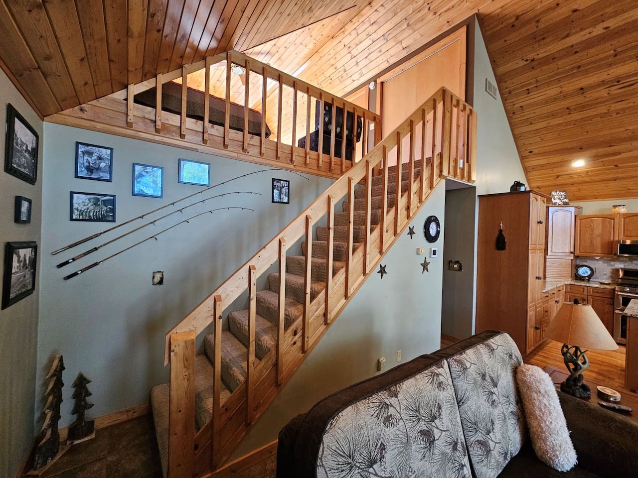 Step into your cozy cabin retreat with rustic wood ceilings, charming loft space, and thoughtfully decorated walls creating the perfect mountain getaway.
