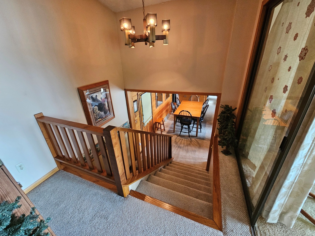 You'll love the warm wood details and elegant chandelier as you move between floors of your spacious retreat.