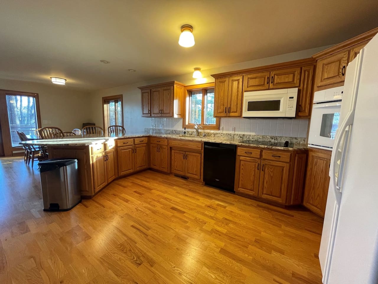 Your spacious kitchen features rich wood cabinetry, granite counters, and modern appliances perfect for preparing memorable meals.