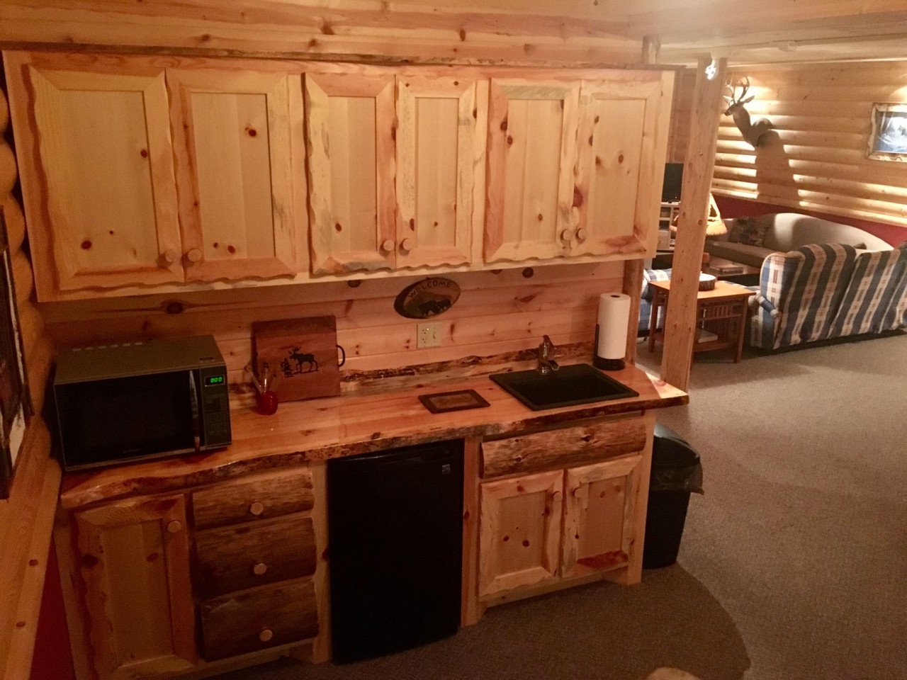 Your cozy cabin kitchenette features rustic pine cabinetry and modern appliances for your convenience.