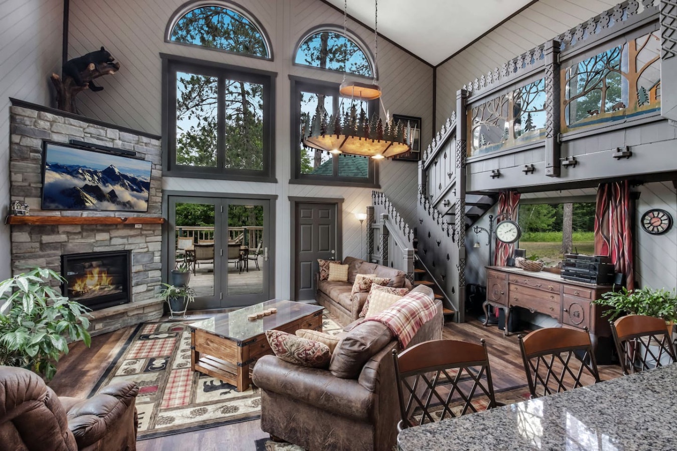 Cozy up by your stone fireplace in this stunning mountain cabin with soaring ceilings and rustic charm.