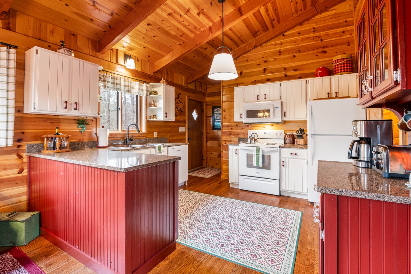 Warm wood beams embrace this fully-equipped kitchen where you'll create memorable meals among granite counters and rustic charm.