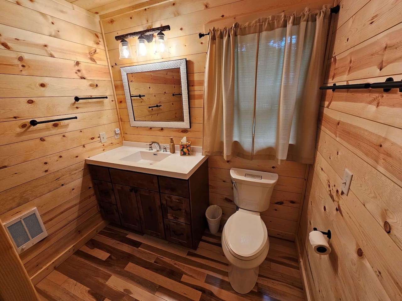 Step into your cozy log cabin bathroom where rustic wood walls create a warm, mountain retreat atmosphere for your morning routine.