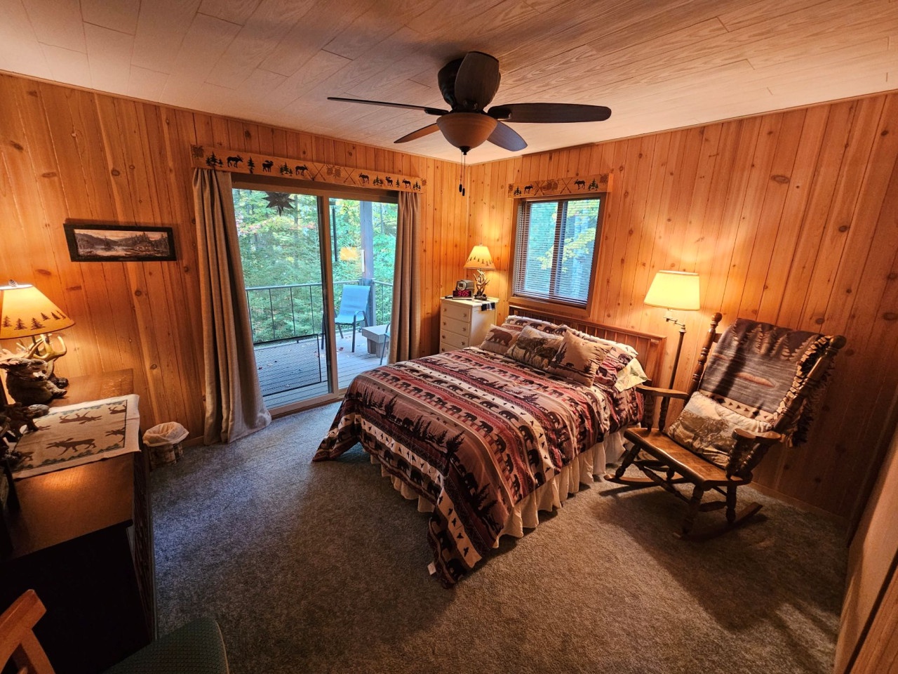 Drift off surrounded by warm wood walls and rustic charm in your cozy retreat, where soft lighting creates perfect ambiance.