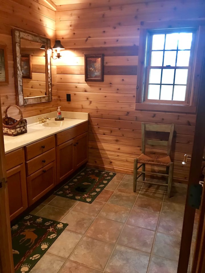 Unwind in your rustic cabin bathroom with warm wood walls, charming natural light, and thoughtful touches that make freshening up feel like a retreat.