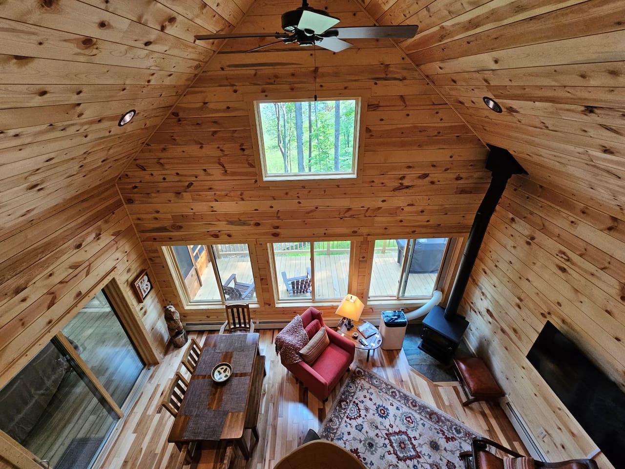Relax in this charming loft space where warm wood surrounds you, natural light streams through tall windows, and cozy seating awaits your mountain retreat.