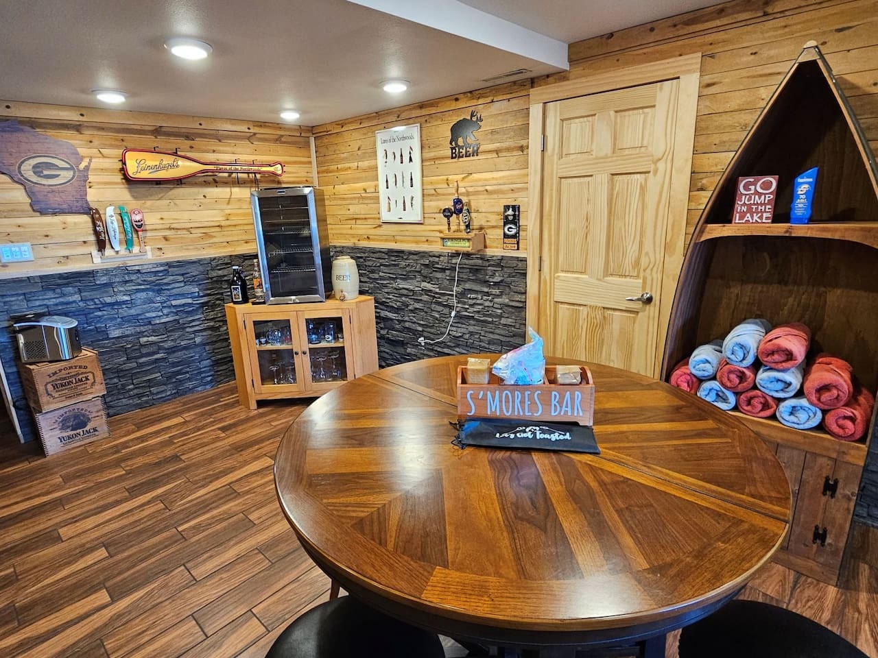 Your cozy game room awaits with a s'mores bar, beer tap, and lake-themed touches perfect for unwinding after adventurous days.