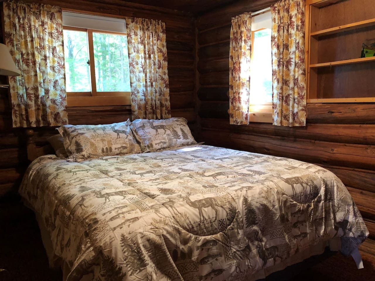 Sink into this cozy cabin bedroom where rustic log walls and nature-themed bedding create your perfect woodland retreat sanctuary.