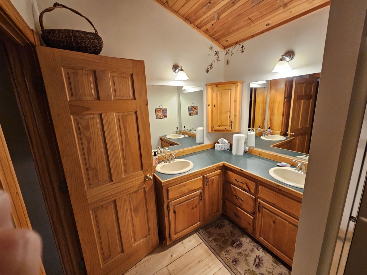 Freshen up in your beautifully appointed bathroom with double sinks, rich wood cabinetry, and charming rustic details.