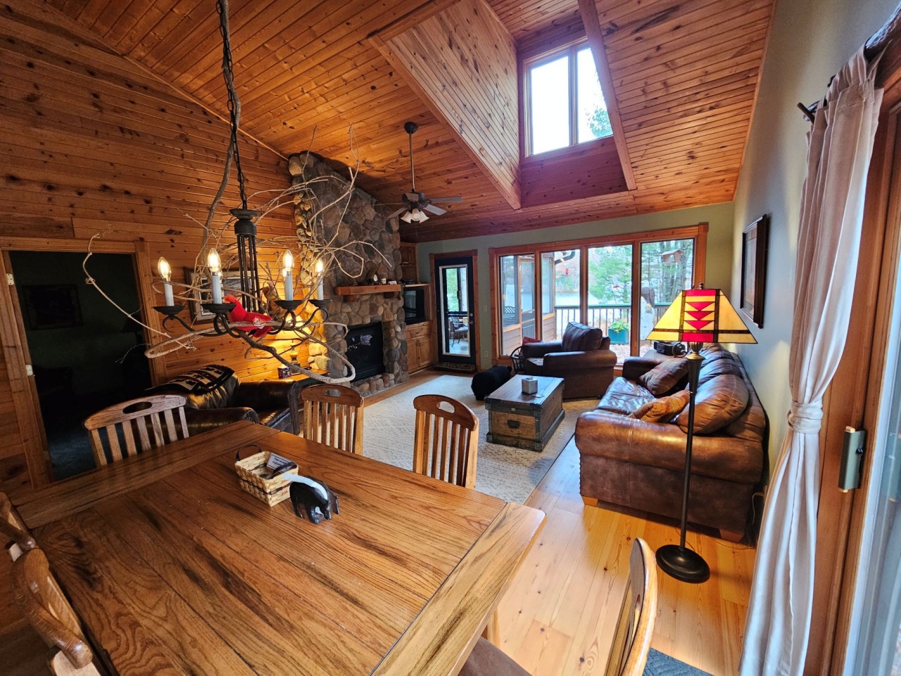 Cozy up by your stone fireplace in this rustic cabin where warm wood beams create the perfect mountain retreat atmosphere.