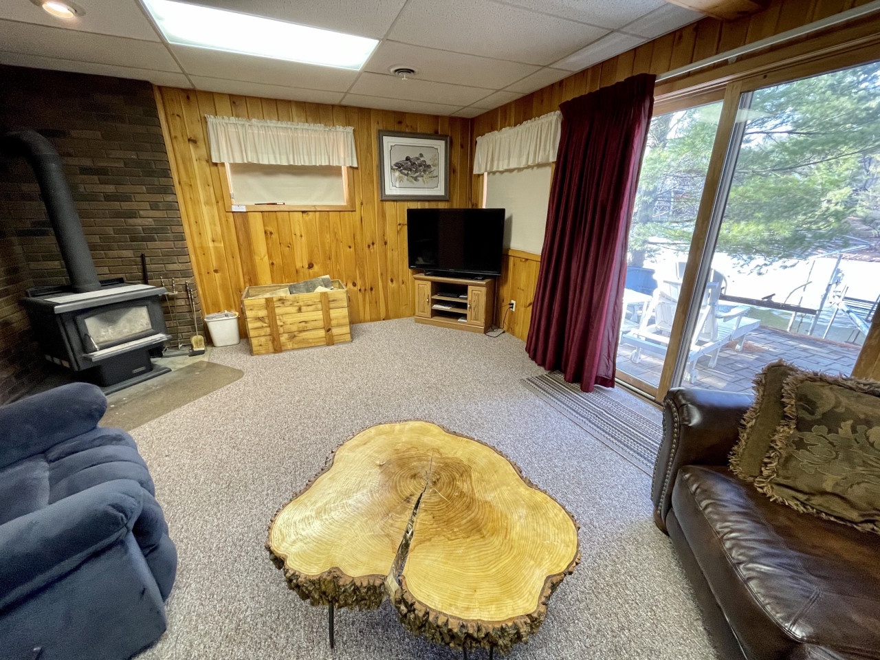 Cozy up by your wood-burning fireplace while enjoying the unique live-edge coffee table and entertainment center in this warm, cabin-style retreat.