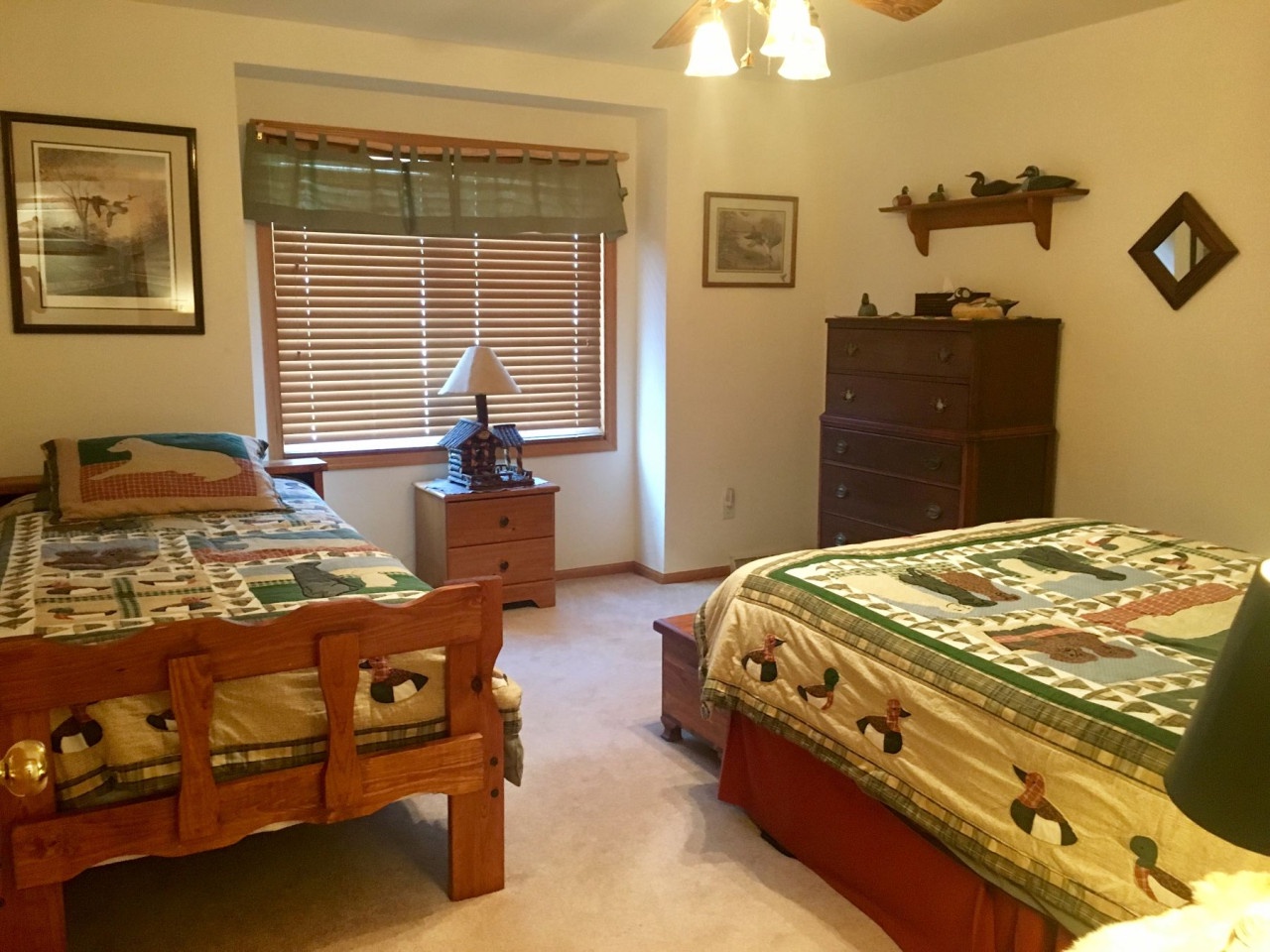 Your cozy bedroom features two comfortable beds with charming quilted bedding, perfect for sharing with family or friends during your stay.