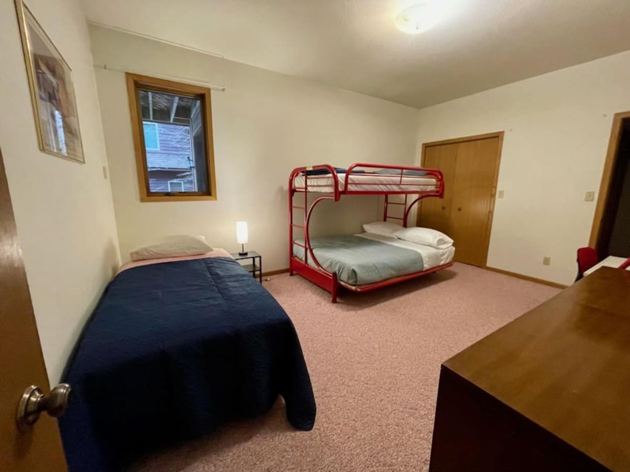 Your spacious bedroom features comfortable beds for the whole family, with bright natural light and cozy carpeting for relaxation.