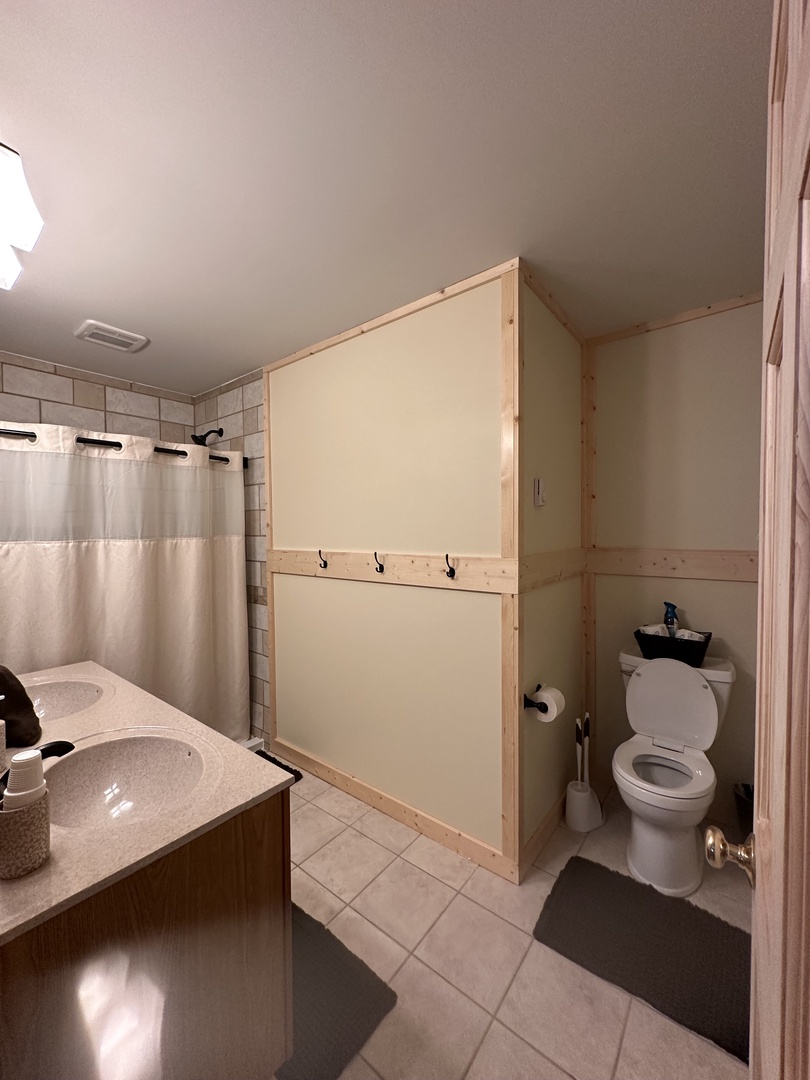 Your private bathroom features modern fixtures and clean tile flooring for a refreshing start to each morning.