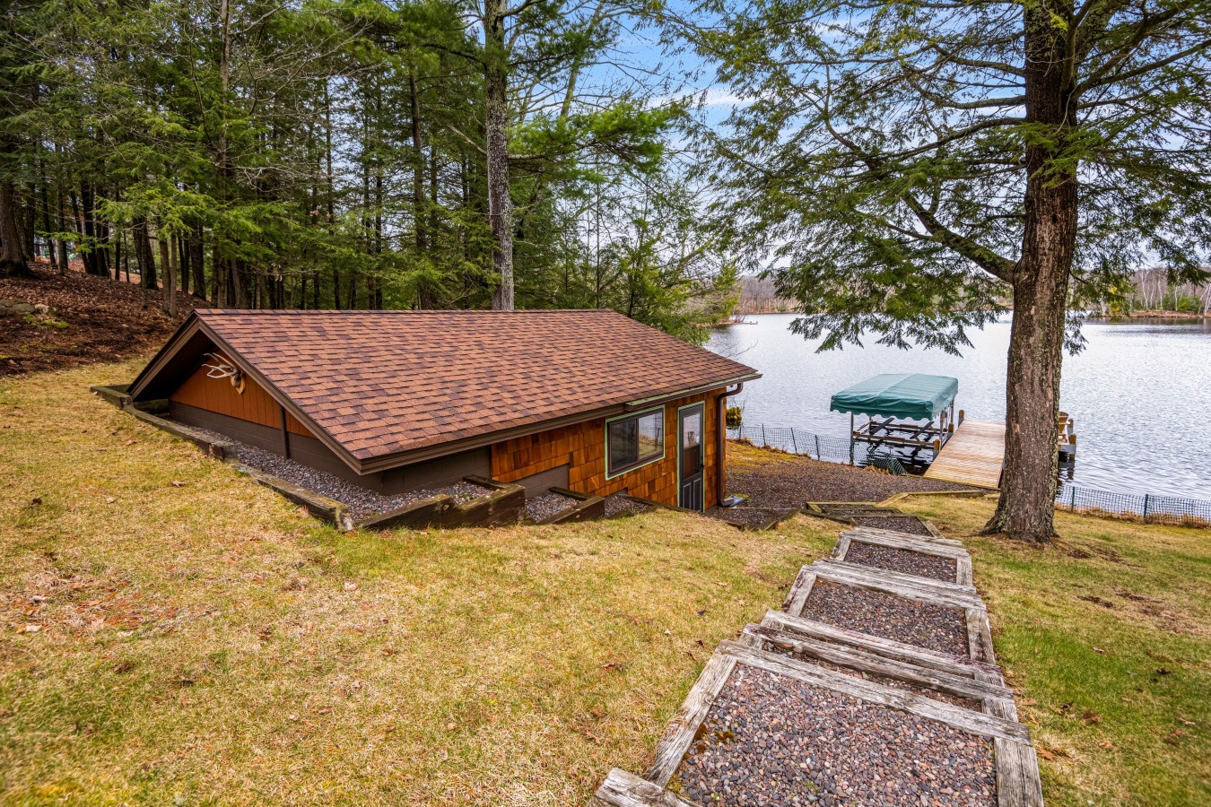 Cozy lakefront cabin nestled among towering pines with private dock and peaceful water views awaiting your perfect retreat.