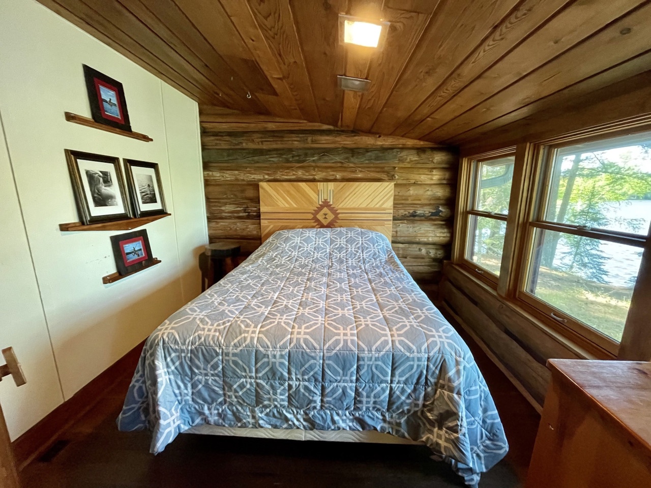 Drift off to sleep in your cozy cabin bedroom, where warm wood surrounds you and garden views greet you each morning.