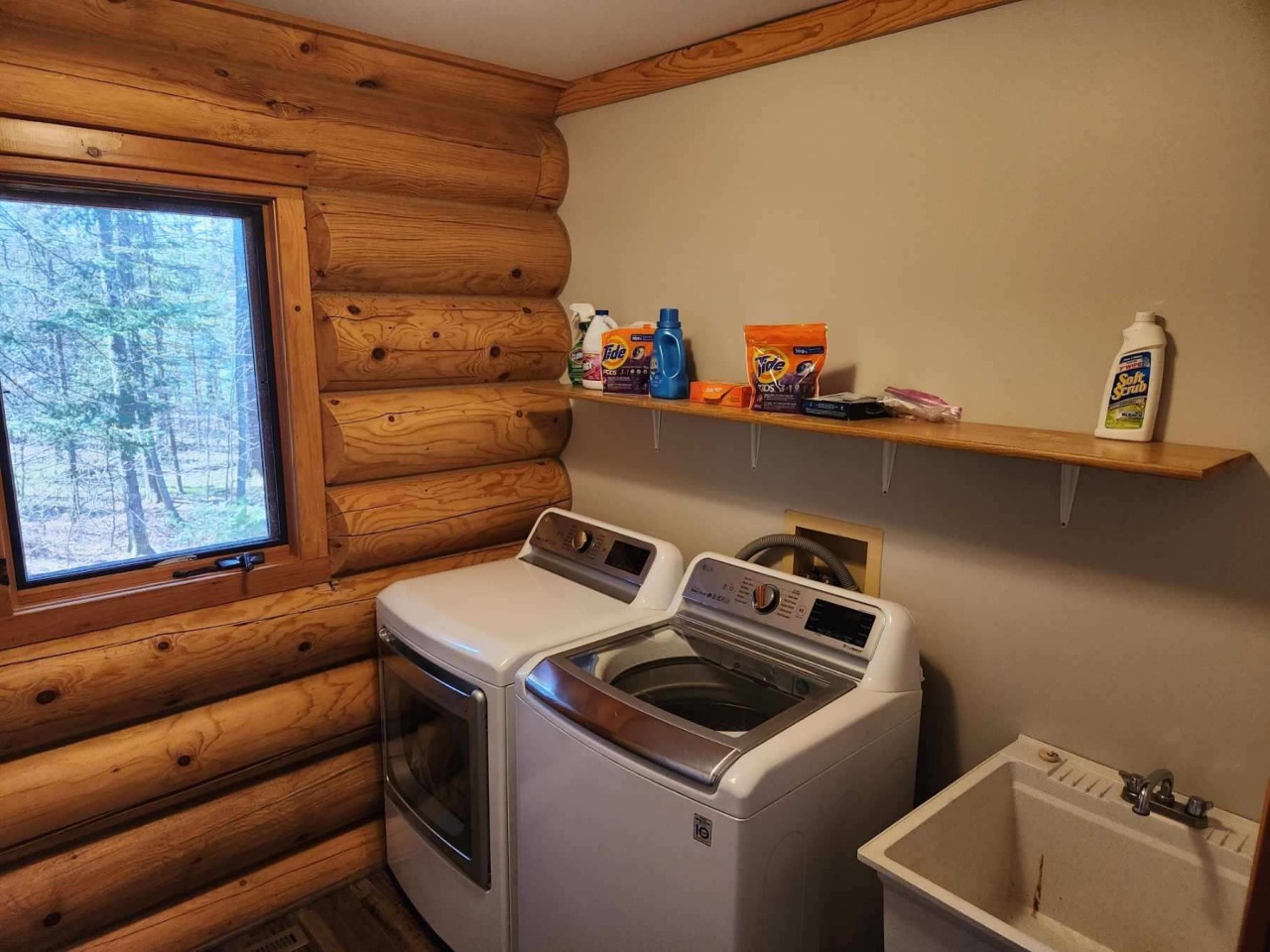 Your private laundry room features modern appliances and peaceful forest views while you tackle daily tasks.